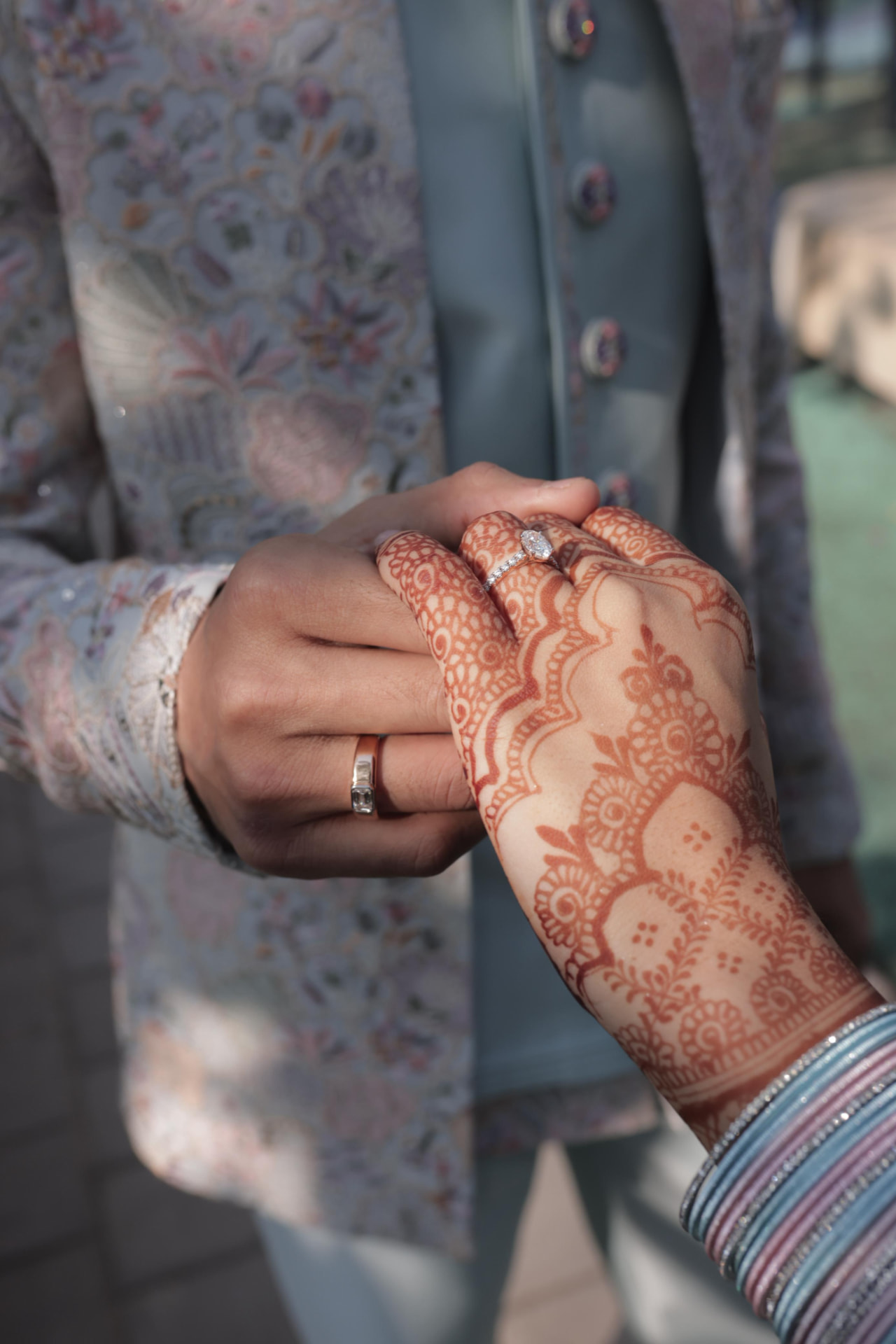Vidhi and Jash holding hands, mehendi and ring